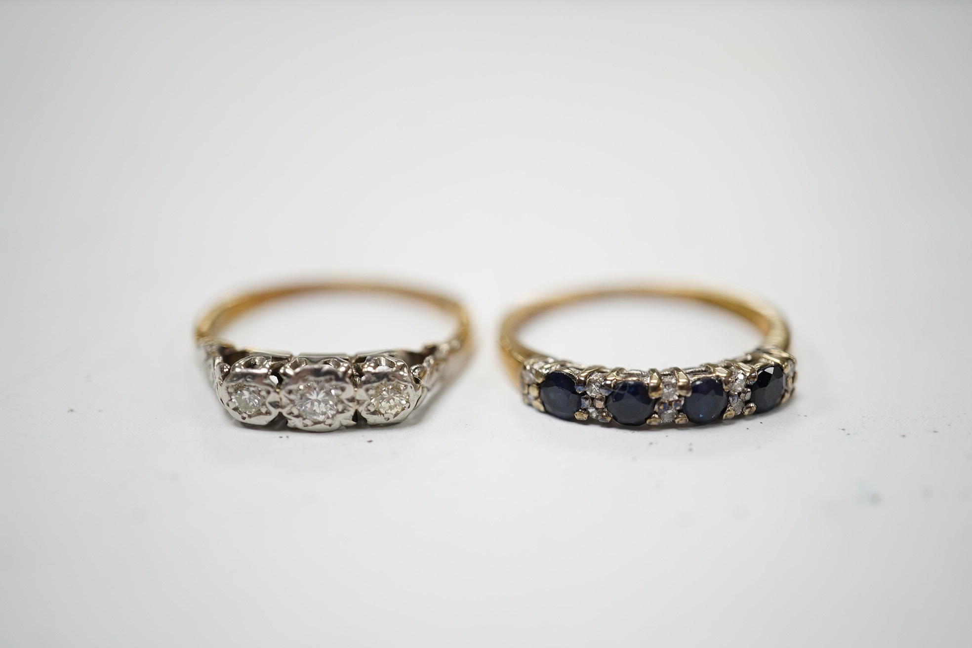 A yellow metal and illusion set three stone diamond ring, size M and a 9ct gold and five stone sapphire set half hoop ring, with diamond chip spacers, size N, gross weight 4.6 grams. Condition - fair